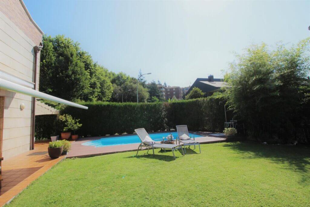 The villa's lovely pool area - by Booking